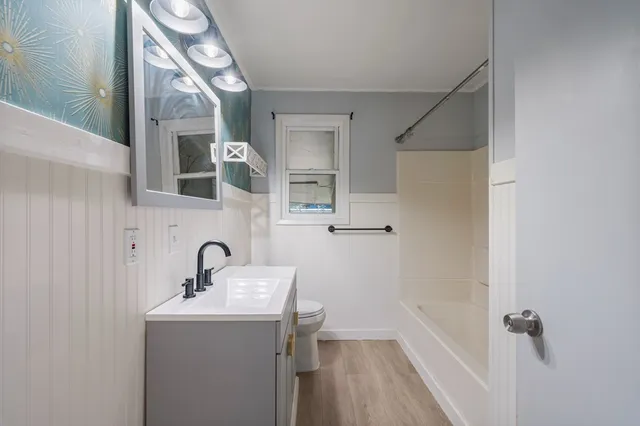a bathroom with a sink toilet and shower