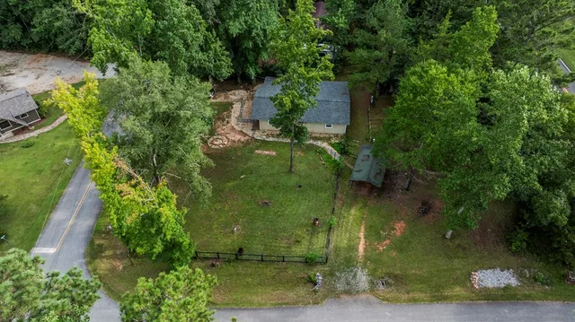 an aerial view of a house with a yard