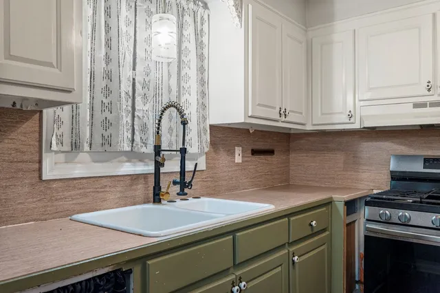 a kitchen with a sink and cabinets