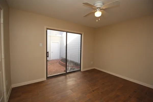 an empty room and chandelier fan