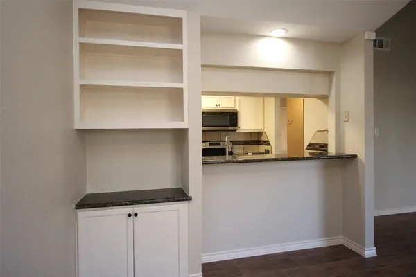 a kitchen with a refrigerator a stove and a cabinets