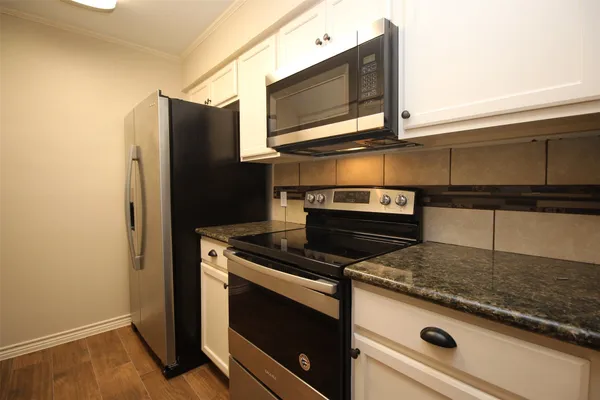 a stove top oven sitting inside of a kitchen