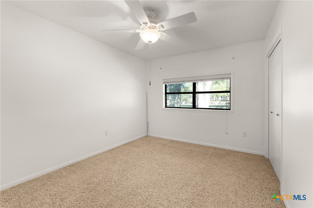 1830 Fm 221 Hamilton, TX 76531 - Photo 16 of 45 an empty room with windows and ceiling fan