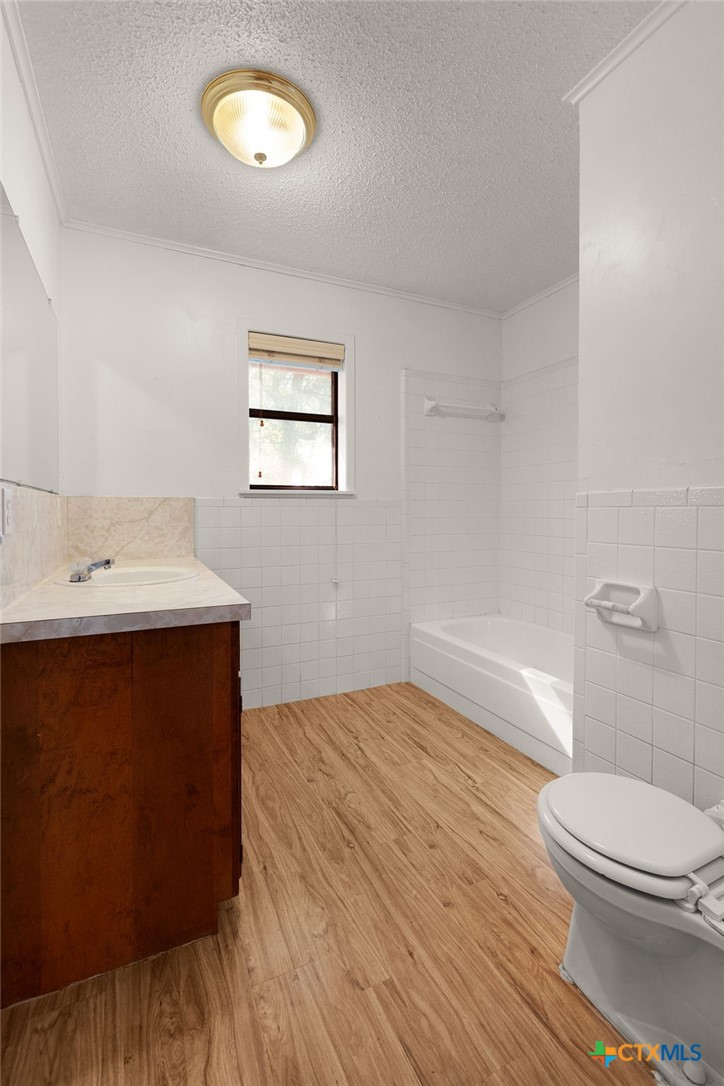 1830 Fm 221 Hamilton, TX 76531 - Photo 18 of 45 a bathroom with a sink mirror vanity and toilet