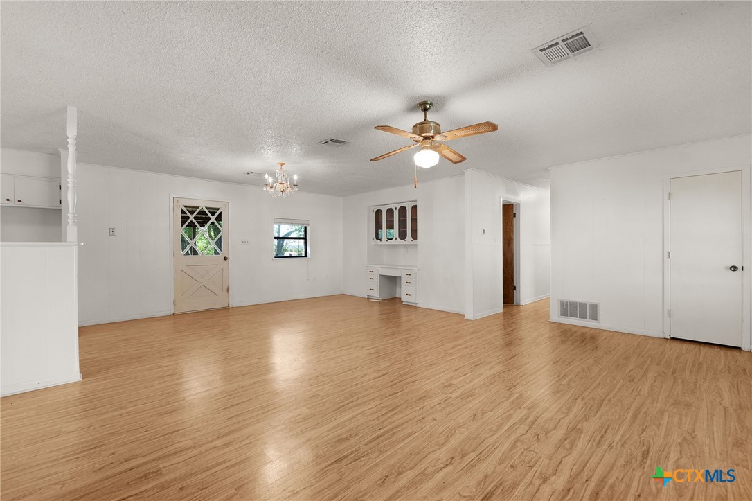 1830 Fm 221 Hamilton, TX 76531 - Photo 6 of 45 an empty room with wooden floor and windows