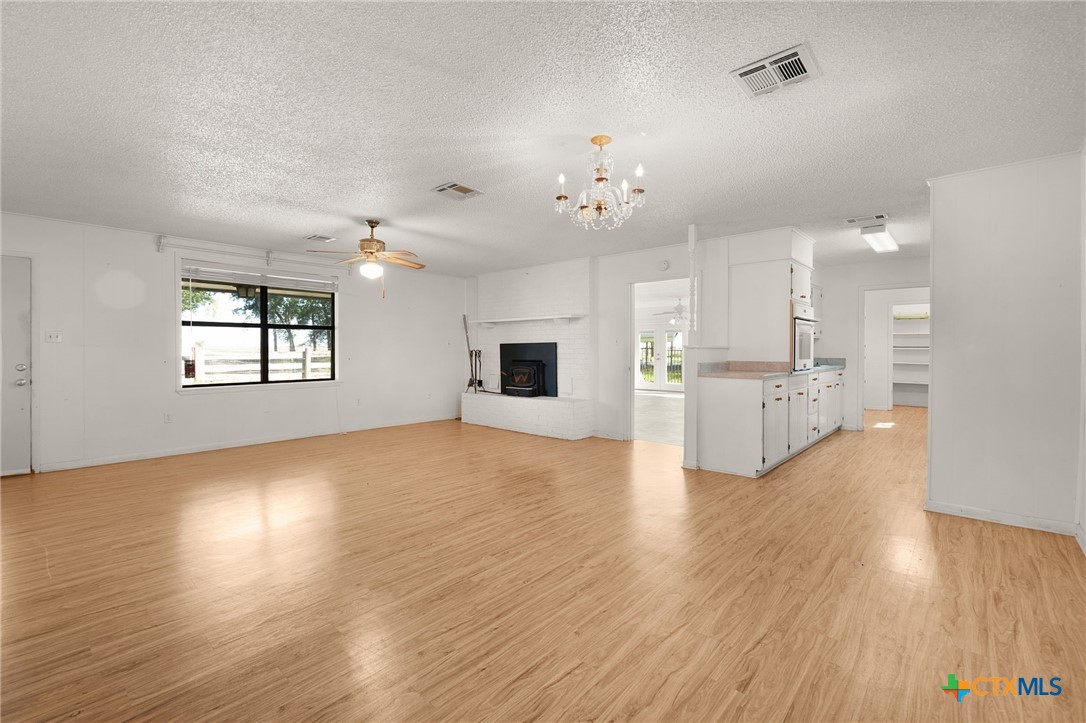 1830 Fm 221 Hamilton, TX 76531 - Photo 8 of 45 a view of a kitchen with a kitchen island wooden floor and a window