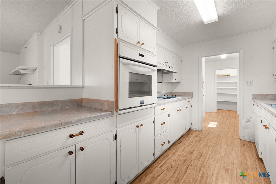 1830 Fm 221 Hamilton, TX 76531 - Photo 10 of 45 a kitchen with granite countertop white cabinets and white appliances