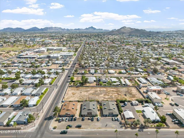 an aerial view of residential building and car parked on street side