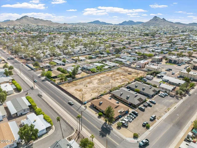 an aerial view of residential houses with city view