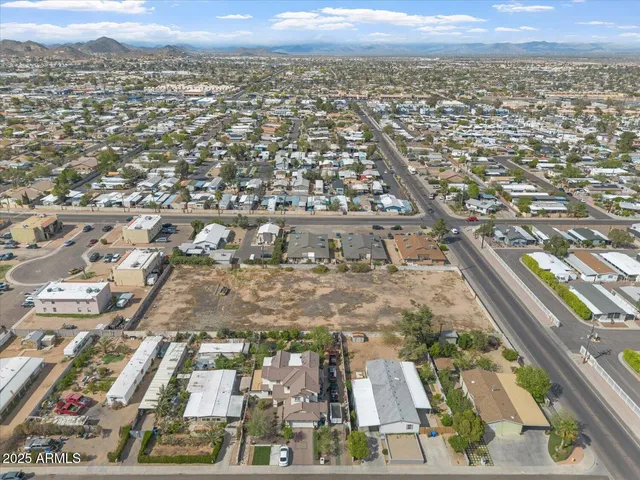 an aerial view of residential houses with city view