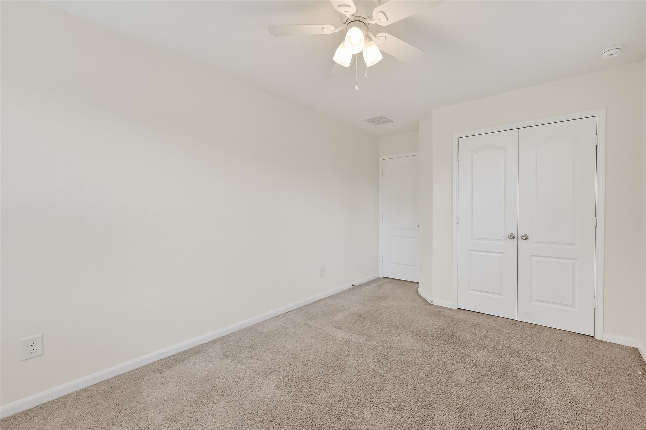 2107 Parnevik Place Conroe, TX 77304 - Photo 34 of 44 Bedroom 3 with a view of the entry and closet doors