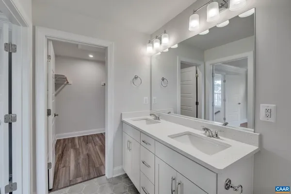 a bathroom with a sink double vanity and a mirror