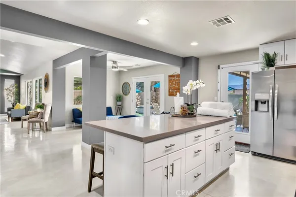 a kitchen with counter top space and living room view