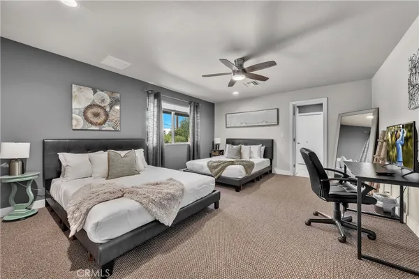 a bedroom with a bed a desk and chair