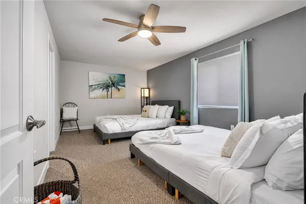 a bedroom with a bed couch and window