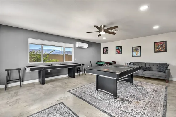 a living room with furniture a rug and a large window