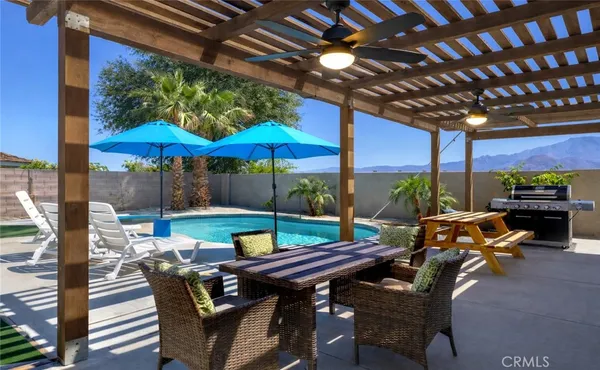 a view of an outdoor sitting area with furniture and umbrella