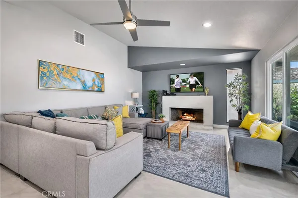 a living room with furniture and a fireplace