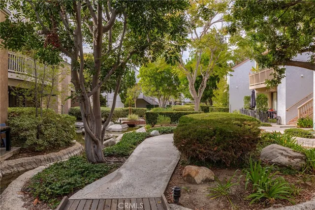a backyard of a house with a garden and outdoor seating