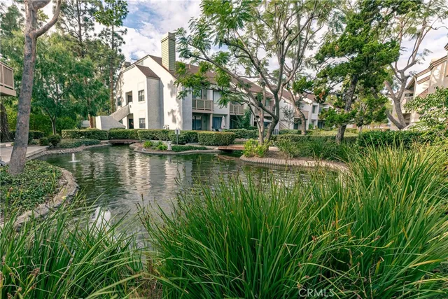 a view of a house with river in front of it