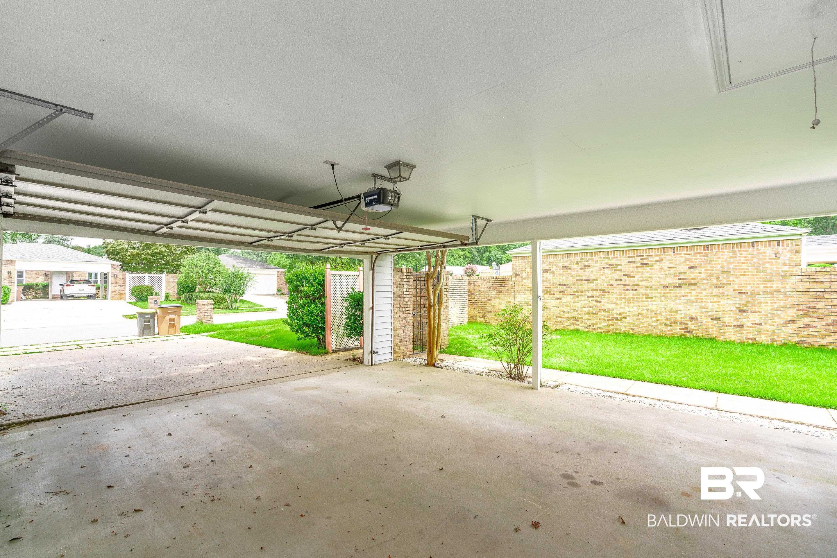 23 Old Mill Court Mobile, AL 36608 - Photo 35 of 37 Garage featuring a garage door opener