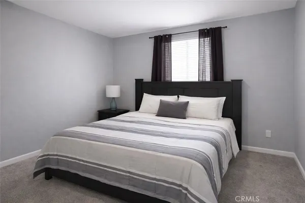 a bedroom with a bed and window