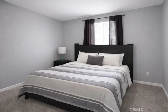 a bedroom with a bed and window