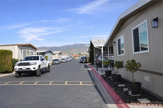 a view of city street with couple of cars parked on road