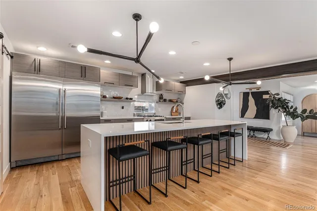 a kitchen with a table chairs refrigerator and microwave