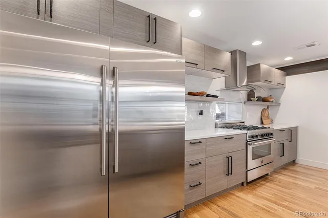 a kitchen with stainless steel appliances a refrigerator sink and cabinets