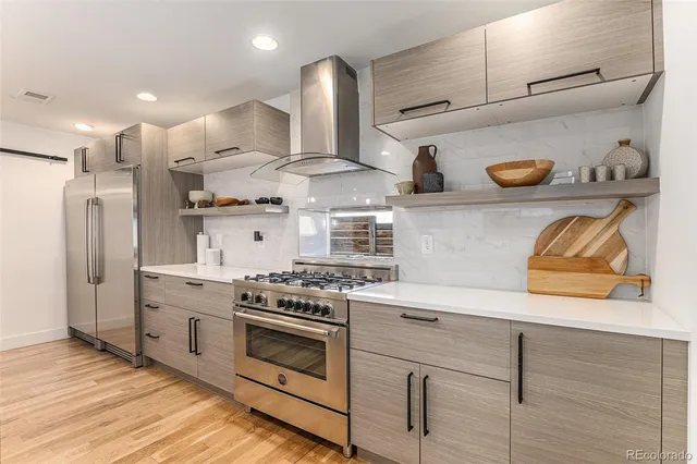 a kitchen with cabinets and stainless steel appliances
