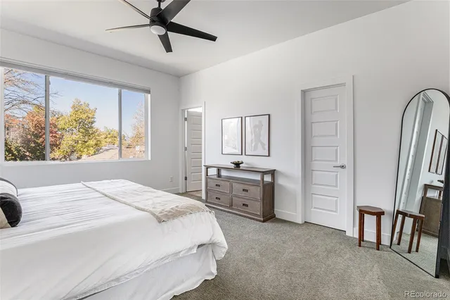 a bedroom with a bed dresser and a window