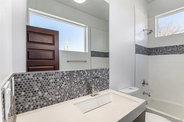 a bathroom with a bathtub and a sink