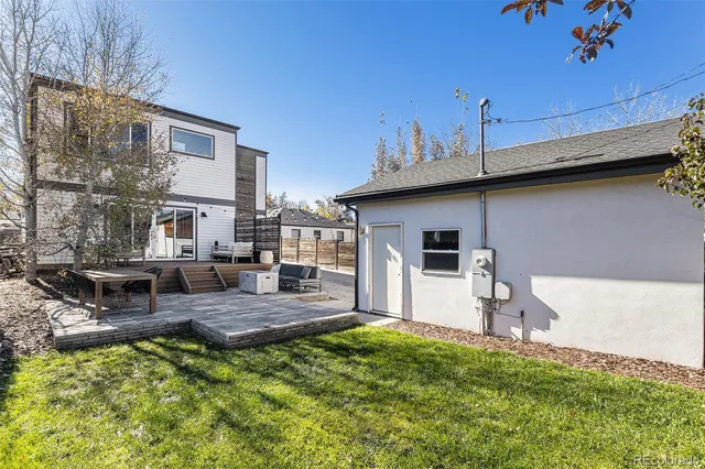 a view of a house with backyard and sitting area