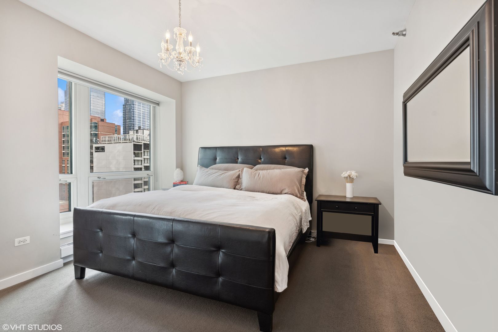 57 East Delaware Place, Unit 1801 Chicago, IL 60611 - Photo 8 of 19 a bed sitting in a bedroom next to a window
