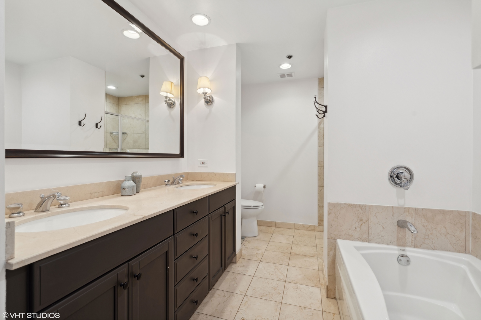 57 East Delaware Place, Unit 1801 Chicago, IL 60611 - Photo 9 of 19 a spacious bathroom with a tub sink mirror and vanity