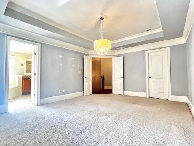a view of a room with a windows and ceiling fan