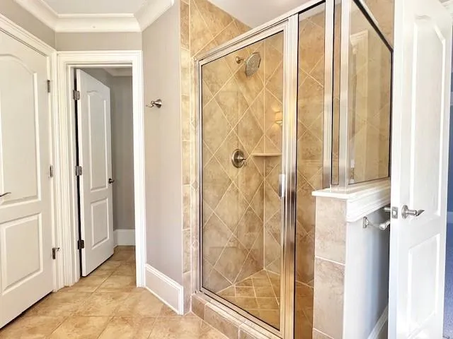 a bathroom with a shower and a glass door