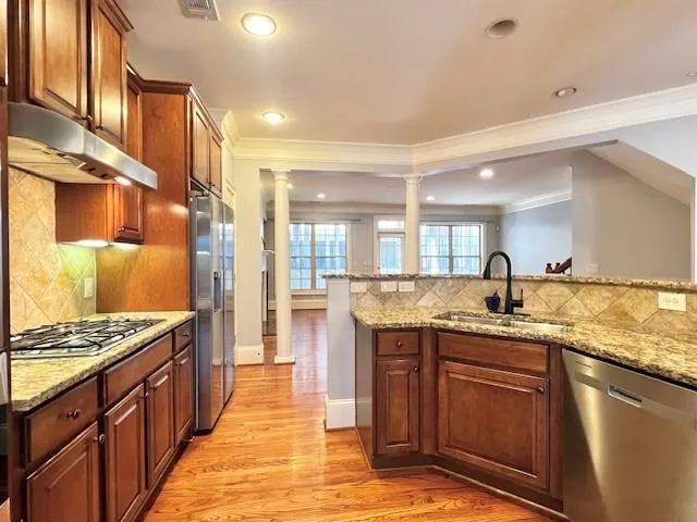 a kitchen with granite countertop a sink stove and cabinets