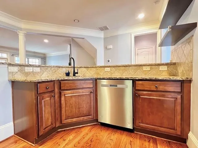 a kitchen with granite countertop cabinets stainless steel appliances and a counter space
