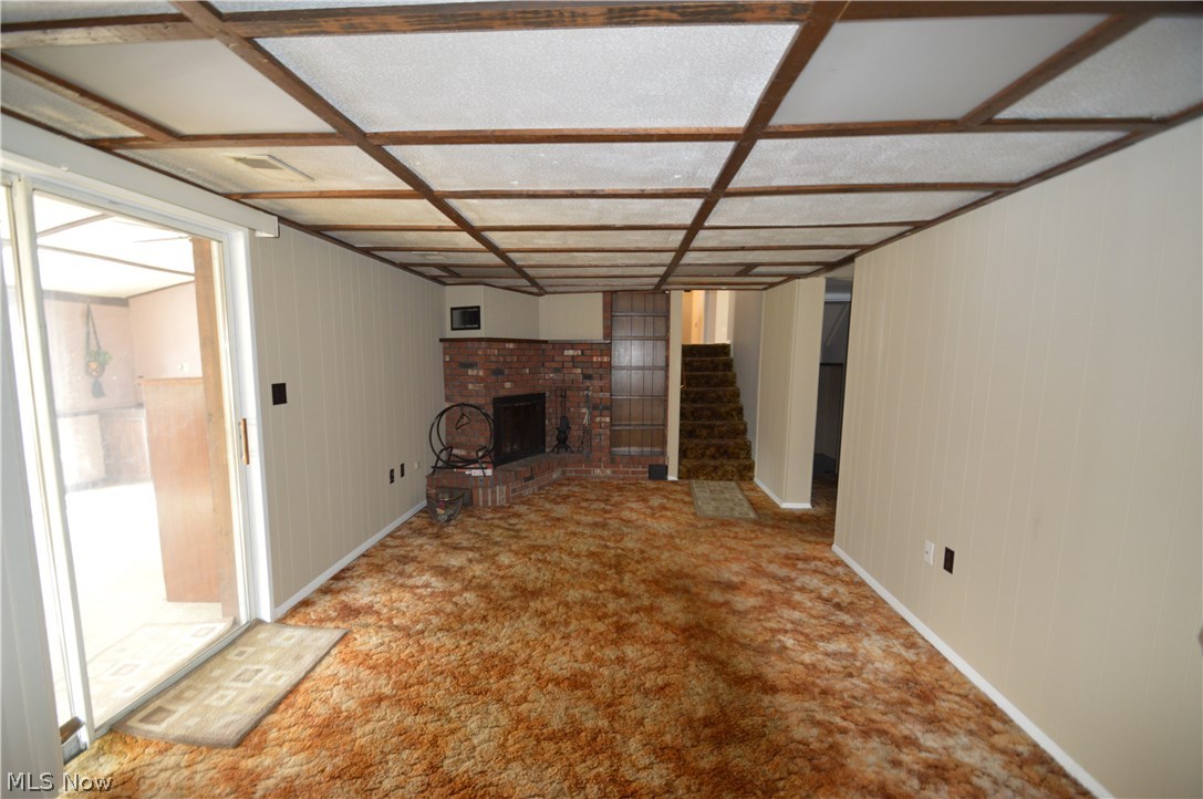 525 Howland Wilson Road Northeast Warren, OH 44484 - Photo 14 of 26 Family room on lower level. Fireplace & Bar area, sliders to Florida room