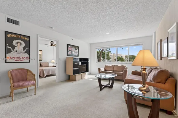 a living room with furniture and a large window