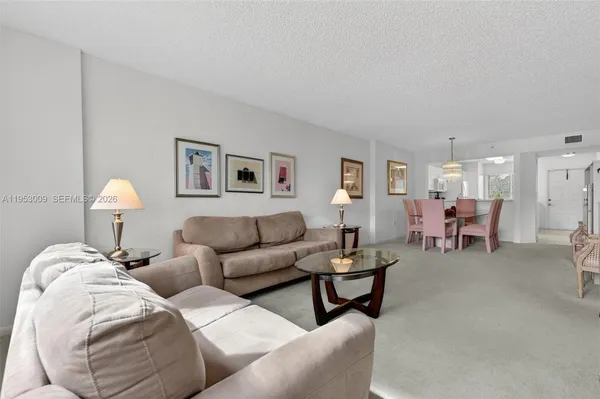 a living room with furniture and a lamp