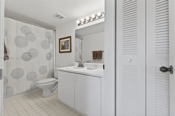 a white toilet sitting next to a bathroom sink