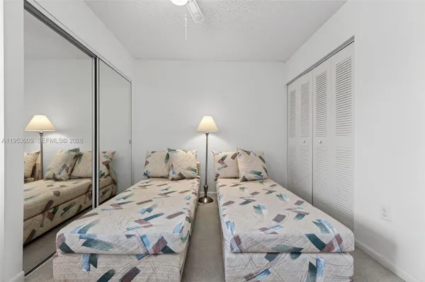 a bedroom with a bed and a lamp