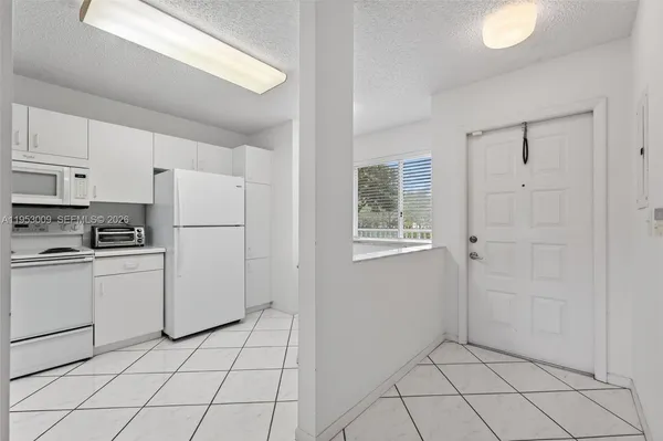 a kitchen with cabinets and white appliances