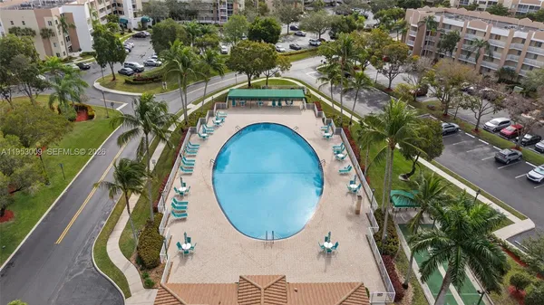 an aerial view of a house with garden space and swimming pool