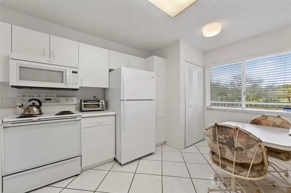 a kitchen with stainless steel appliances granite countertop a refrigerator sink and stove