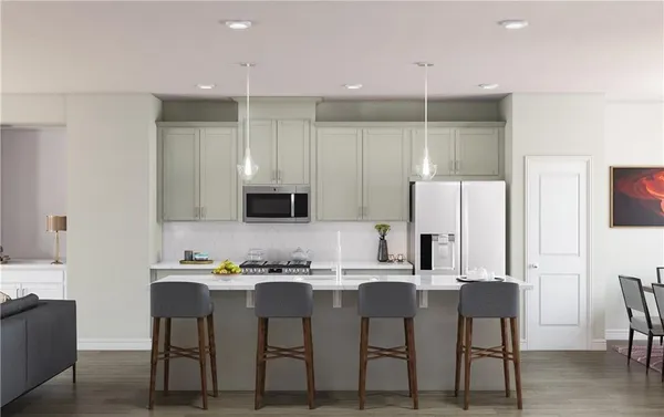 a kitchen with kitchen island cabinets and chairs
