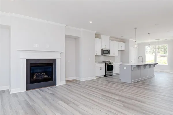 a view of kitchen and fireplace with wooden floor
